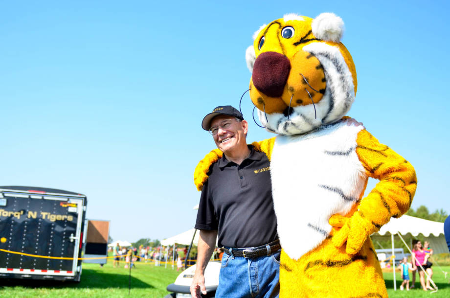 CAFNR Dean Tom Payne strikes a pose with Truman at the 2014 version of the South Farm Showcase. Tom had helped spearhead the event after having success overseeing a similar event at Ohio State in the '90s. Photo by Morgan Lieberman.